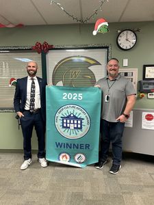 2 administrators holding a banner